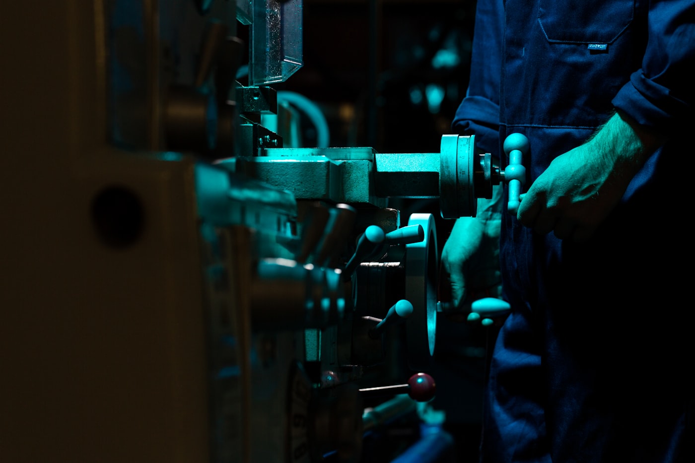 An operator working on industrial machinery on the production floor.